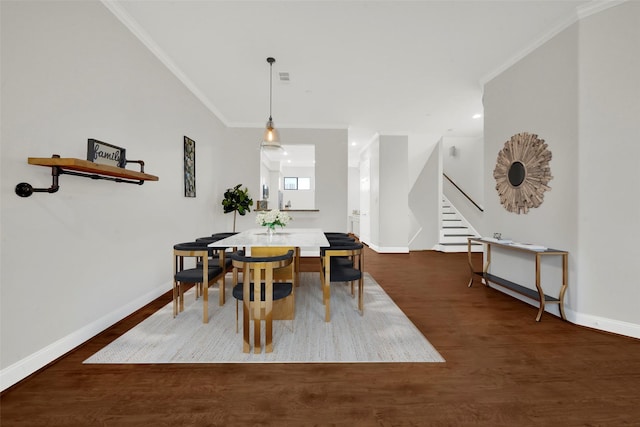 dining area featuring dark hardwood / wood-style flooring and ornamental molding