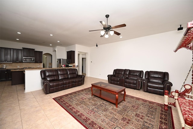 tiled living room with ceiling fan