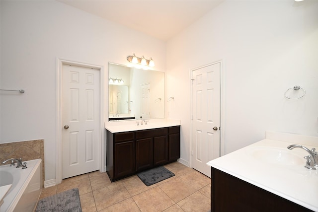 bathroom with vanity, tile patterned flooring, and a bathtub