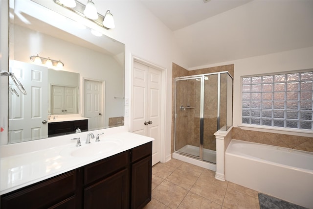 bathroom with tile patterned floors, separate shower and tub, vanity, and vaulted ceiling