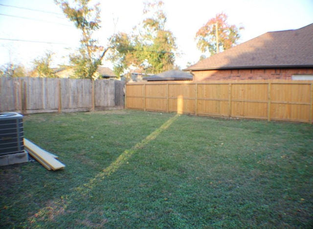 view of yard featuring central air condition unit