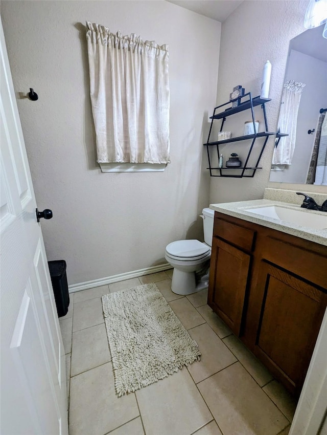 bathroom with tile patterned floors, vanity, and toilet