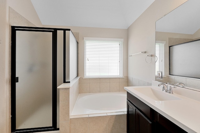 bathroom with shower with separate bathtub, vanity, and lofted ceiling