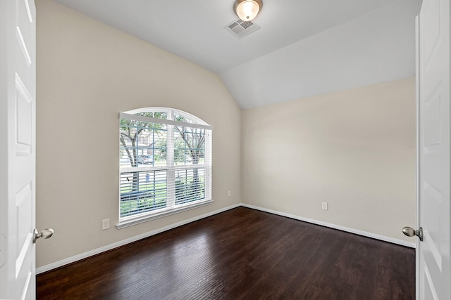 unfurnished room with hardwood / wood-style flooring and vaulted ceiling