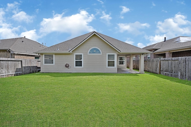 rear view of house featuring a patio area and a yard