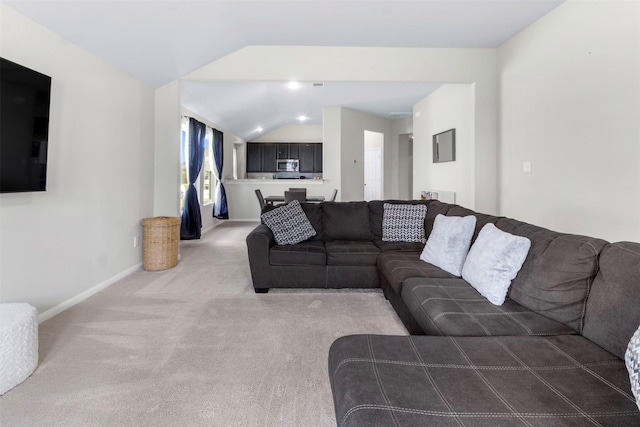 living room with lofted ceiling and carpet flooring