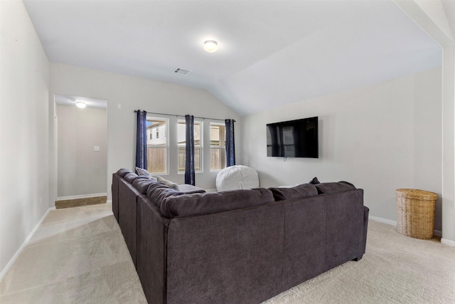 living room featuring light colored carpet and vaulted ceiling