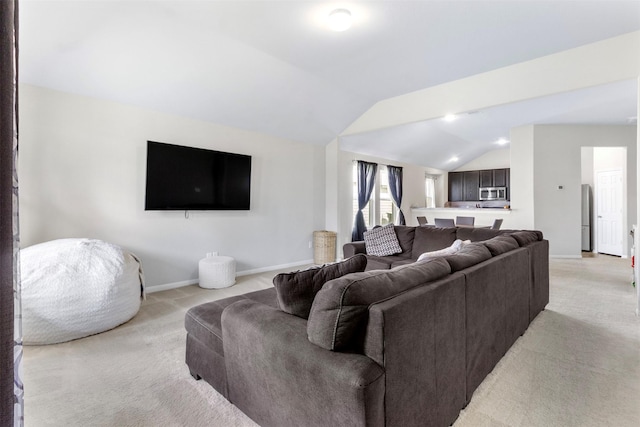 carpeted living room with lofted ceiling