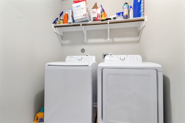 clothes washing area featuring independent washer and dryer