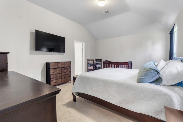 carpeted bedroom with vaulted ceiling