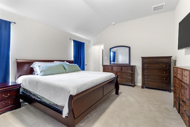 bedroom featuring light colored carpet and vaulted ceiling