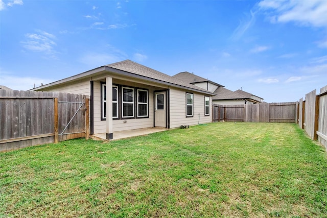 back of property featuring a patio and a lawn