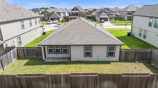 rear view of property featuring a patio and a lawn