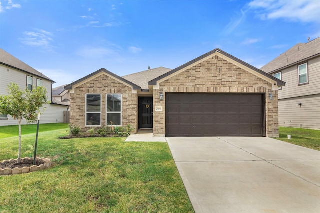 view of front of property with a front yard and a garage