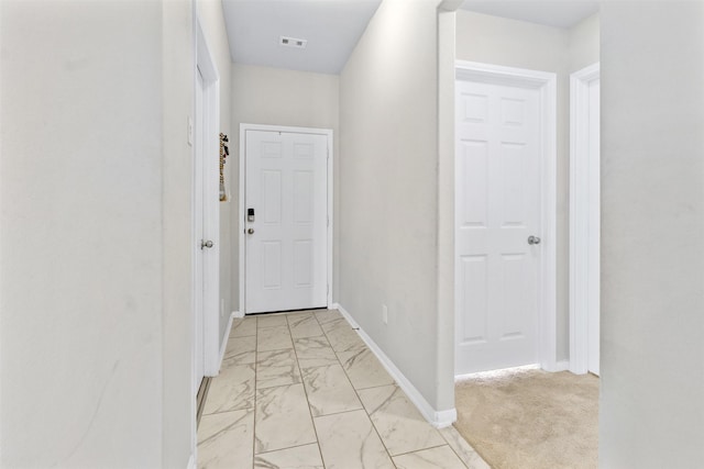 hallway featuring light carpet