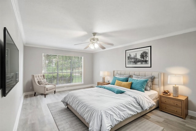 bedroom with ceiling fan, light hardwood / wood-style floors, and crown molding