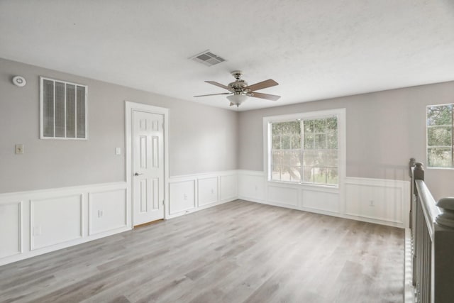 spare room with ceiling fan and light hardwood / wood-style floors