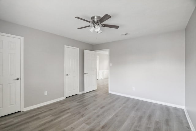 unfurnished bedroom with ceiling fan and light hardwood / wood-style floors