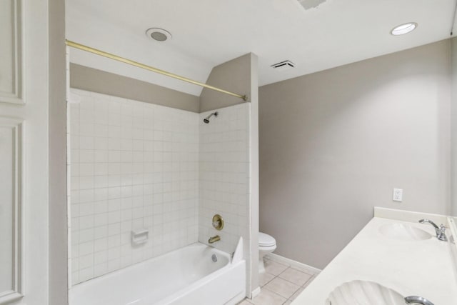 full bathroom featuring toilet, vanity, tiled shower / bath combo, and tile patterned floors