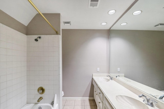 full bathroom featuring tile patterned floors, vanity, toilet, and tiled shower / bath