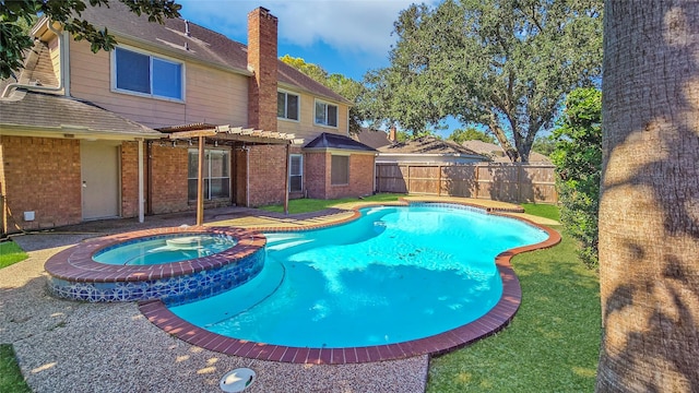 view of swimming pool with an in ground hot tub and a pergola