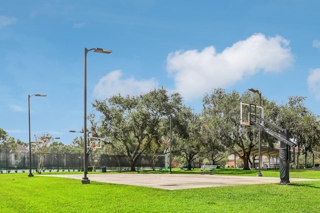 view of basketball court featuring a yard