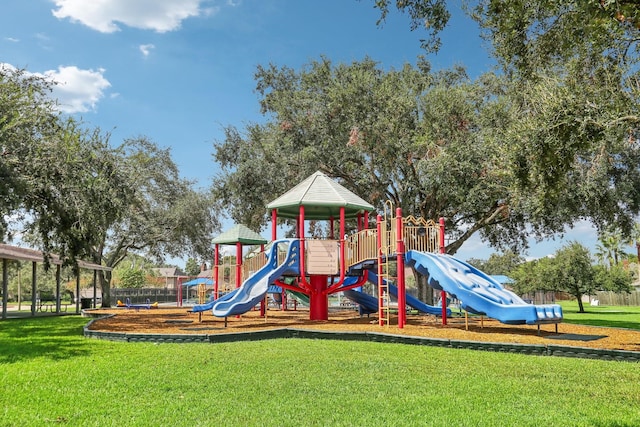 view of playground with a lawn