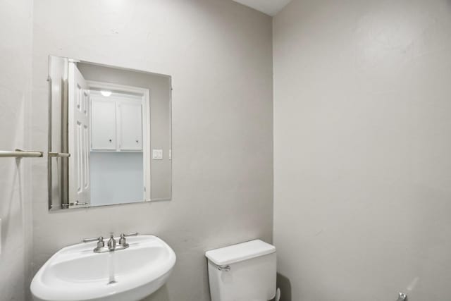 bathroom featuring sink and toilet