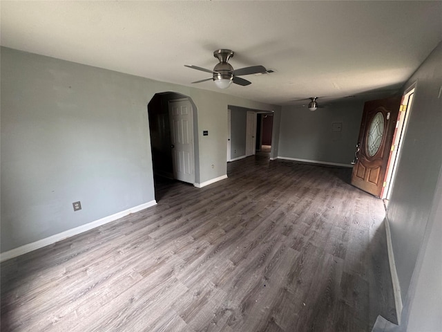 unfurnished living room with ceiling fan and wood-type flooring