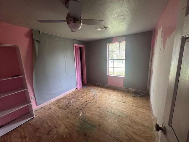 unfurnished bedroom featuring ceiling fan and a textured ceiling