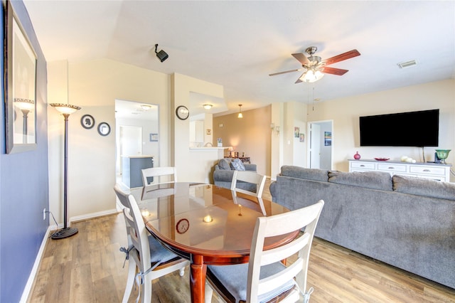 dining area with light hardwood / wood-style floors and ceiling fan