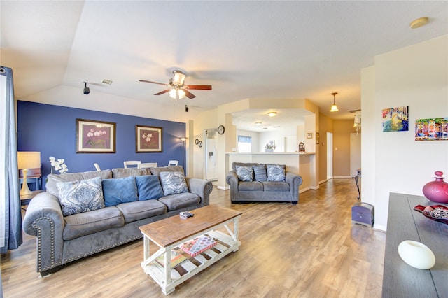 living room with ceiling fan, hardwood / wood-style floors, and lofted ceiling