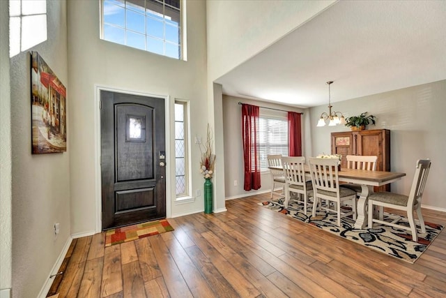 foyer featuring dark wood-type flooring and a chandelier