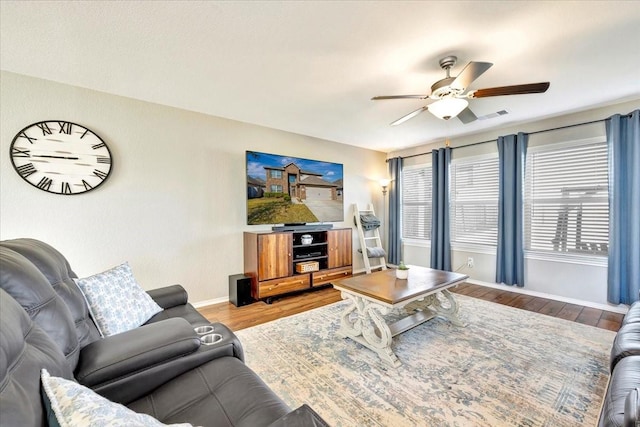 living room featuring hardwood / wood-style floors and ceiling fan