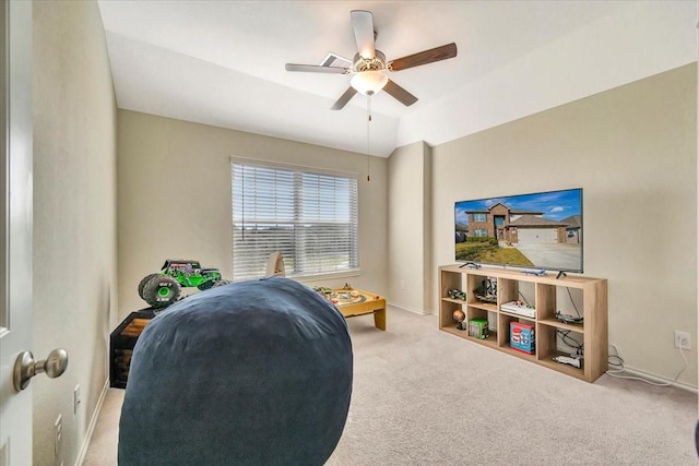 interior space featuring ceiling fan, light colored carpet, and vaulted ceiling