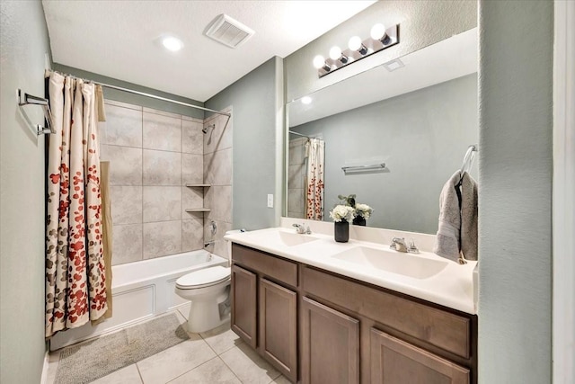 full bathroom featuring tile patterned flooring, vanity, toilet, and shower / tub combo