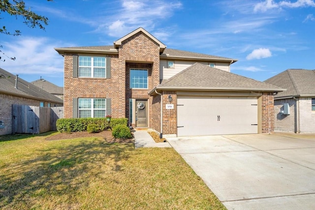 view of property with a garage and a front yard