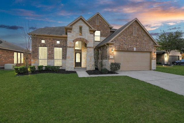 view of front of property with a lawn and a garage