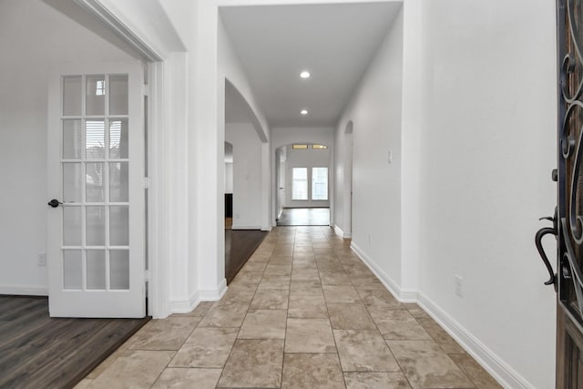 corridor featuring light tile patterned floors