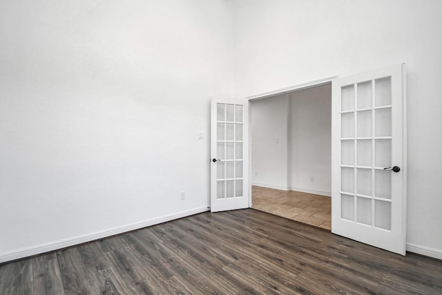 empty room featuring dark wood-type flooring and french doors