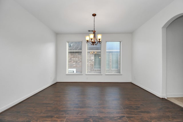 unfurnished dining area featuring dark hardwood / wood-style floors and a notable chandelier