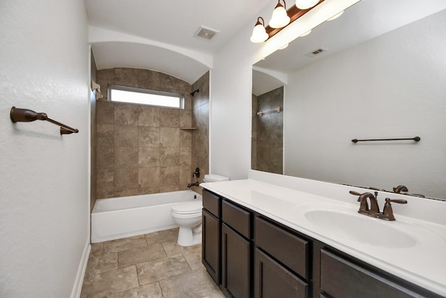 full bathroom featuring vanity, toilet, and tiled shower / bath