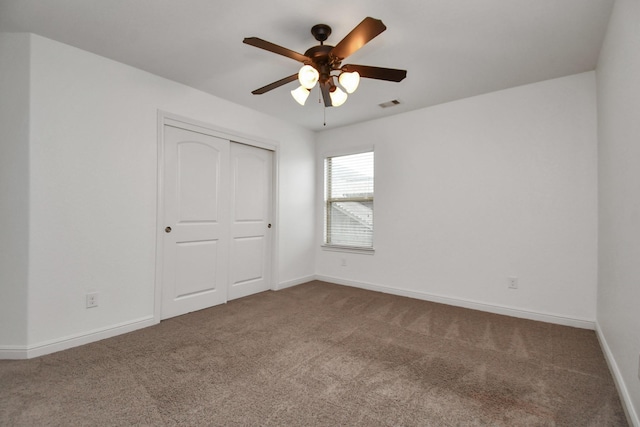 unfurnished bedroom featuring ceiling fan, carpet floors, and a closet