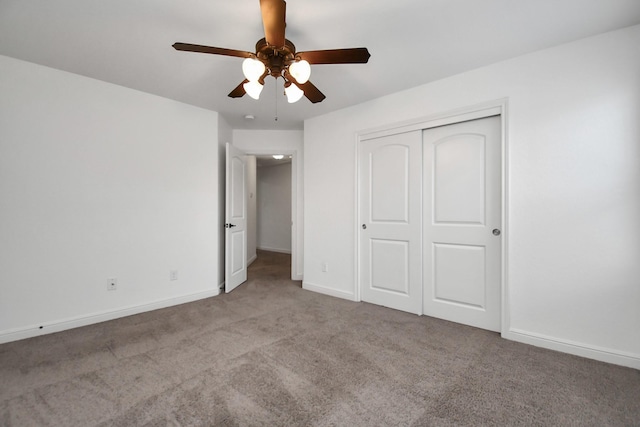 unfurnished bedroom featuring ceiling fan, a closet, and light carpet