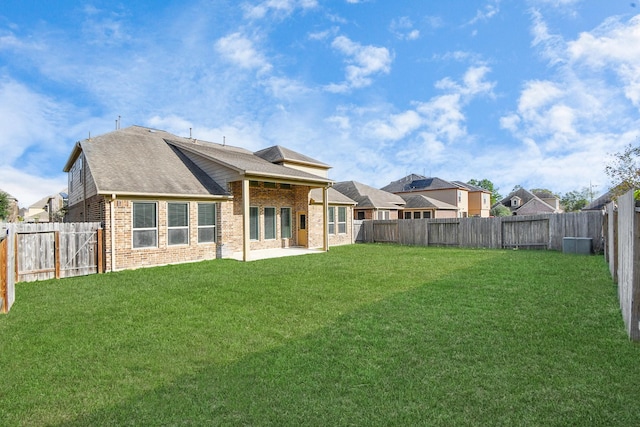 back of house featuring a yard and a patio