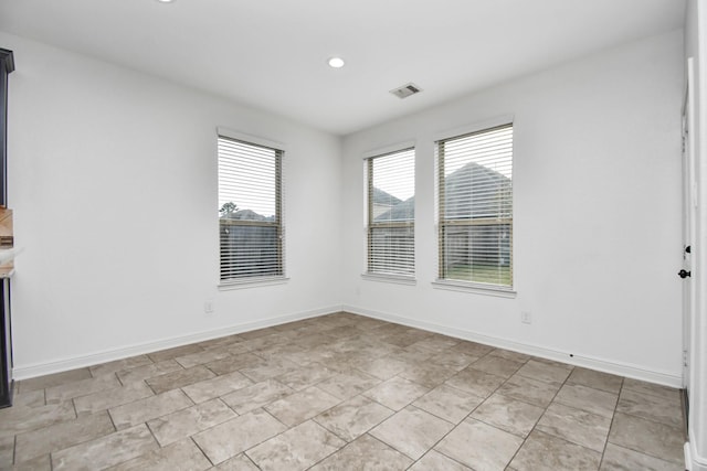 unfurnished room featuring light tile patterned floors