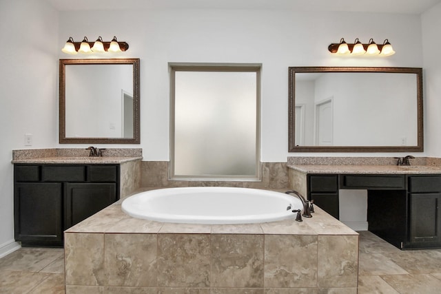 bathroom with vanity and tiled tub