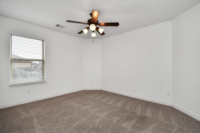 empty room featuring ceiling fan and carpet