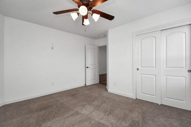 unfurnished bedroom with ceiling fan, carpet floors, and a closet