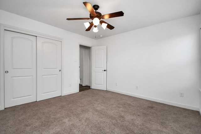 unfurnished bedroom featuring ceiling fan, a closet, and carpet floors